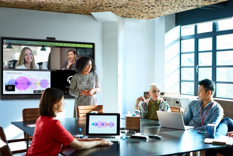 Four people in meeting room on virtual meeting