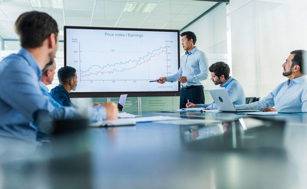 People sitting in conference room looking at presentation