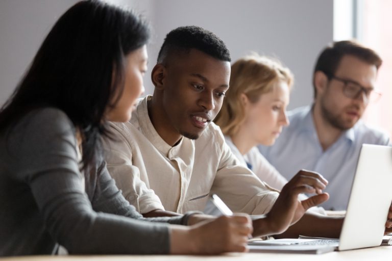 team members looking at laptop