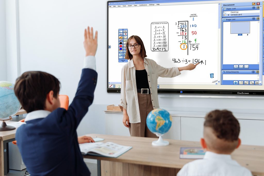 Teacher pointing at interactive panel